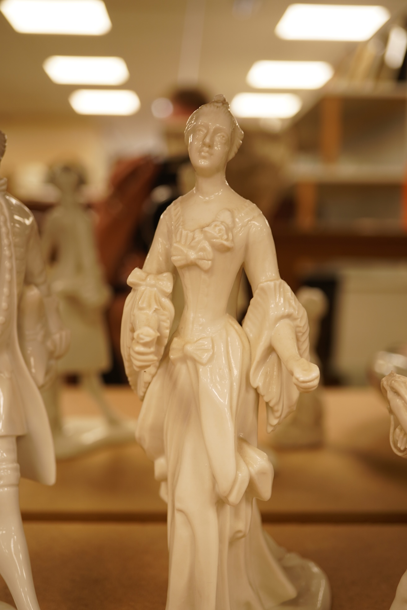 Two Nymphenberg white glazed figures, after Bustelli and two similar cherubs (4) figure 19 cm high